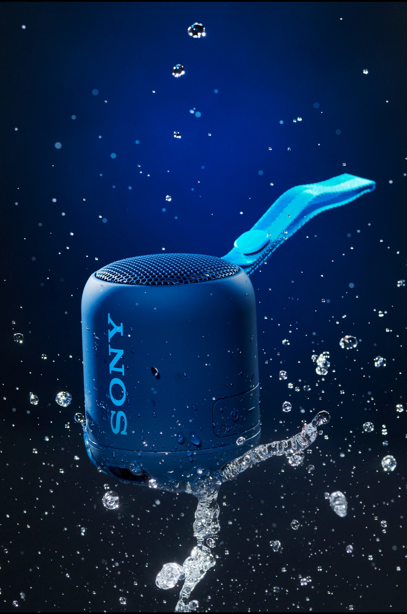 Blue Sony speaker surrounded by suspended water droplets
